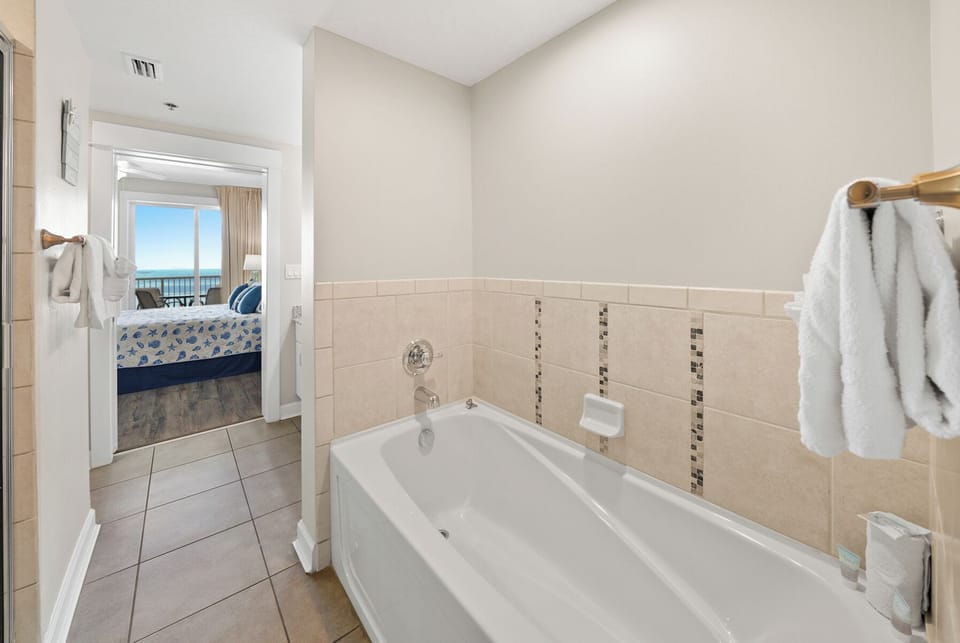 Soak away your stress in this spacious bathtub, with glimpses of your ocean-view bedroom beyond.