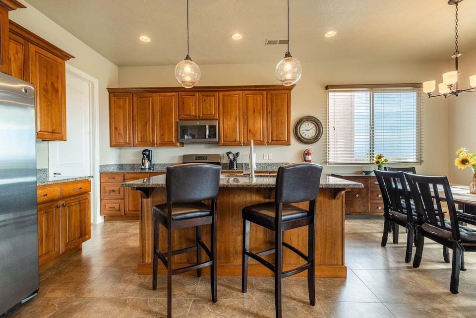 Embrace the charm of this rustic kitchen, adorned with natural wood finishes and classic details. Fully equipped with cooking essentials, it's a delightful space to create culinary masterpieces and savor them with loved ones.