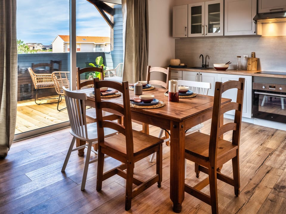 main room opening onto terrace kitchen view