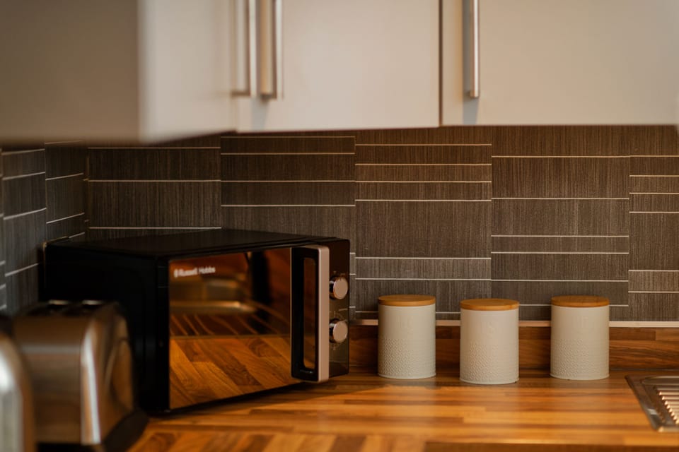 Comfort Apartment | Private kitchen | Full-size fridge, dishwasher, cookware/dishes/utensils, dining tables
