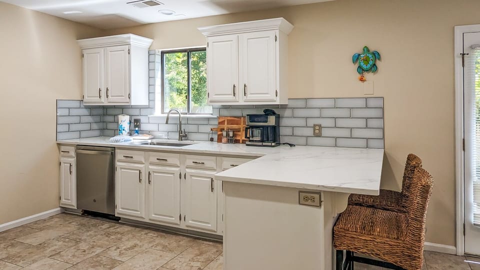 new quartz countertops and glass tile backsplash