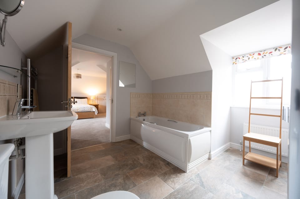First floor: En-Suite with bath, separate shower, wash basin and WC
