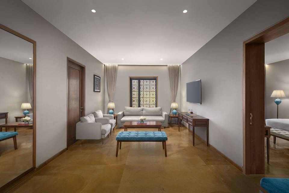 Deluxe Suite | Living room | 40-inch Smart TV with digital channels, TV