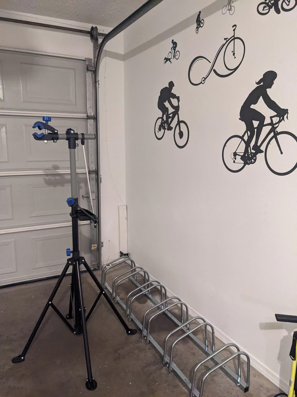 Garage has repair stand, pump, power washer and a different rack than shown here