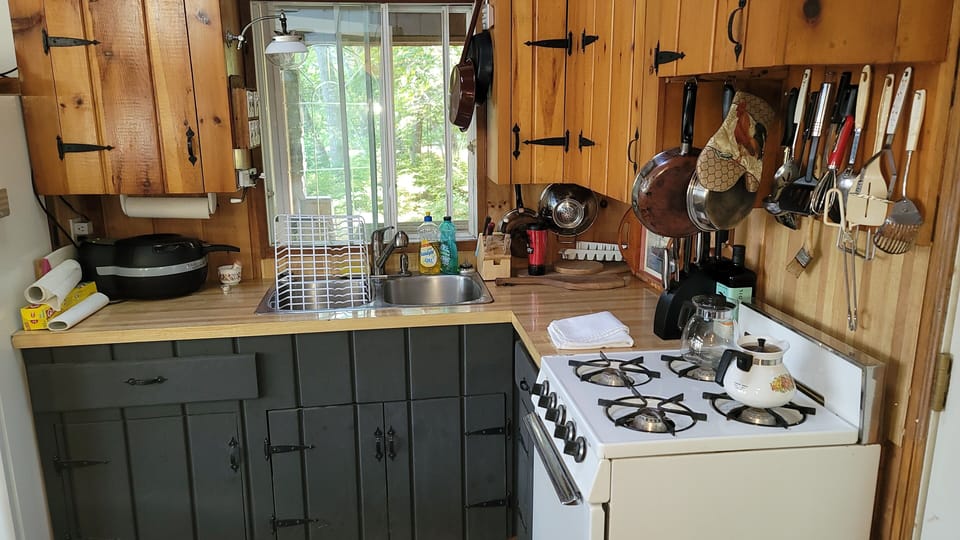 galley kitchen with 4 burner propane stove also a propane lamp for evening light