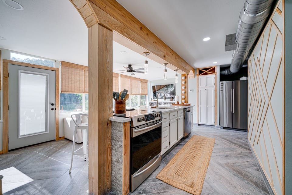 Kitchen is fully equipped with an electric stove with an oven, refrigerator, microwave, and a Keurig