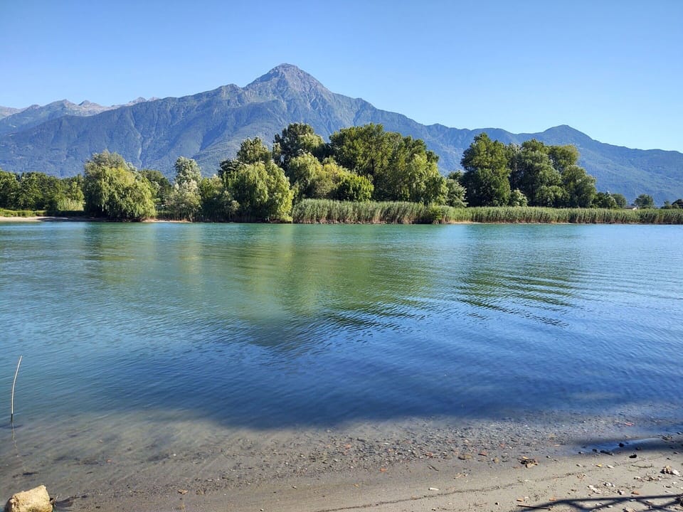 Water, Sky, Mountain, Ecoregion, Azure, Natural Landscape, Tree, Natural Environment, Lake, Coastal And Oceanic Landforms