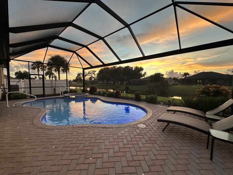 Screened pool with sunset views, perfect for relaxing evenings.