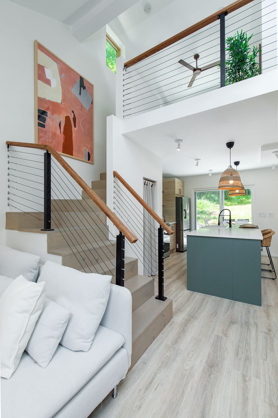 Modern staircase in between living room and kitchen