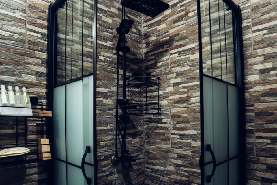 Rainfall showerhead, designer toiletries, hair dryer, slippers