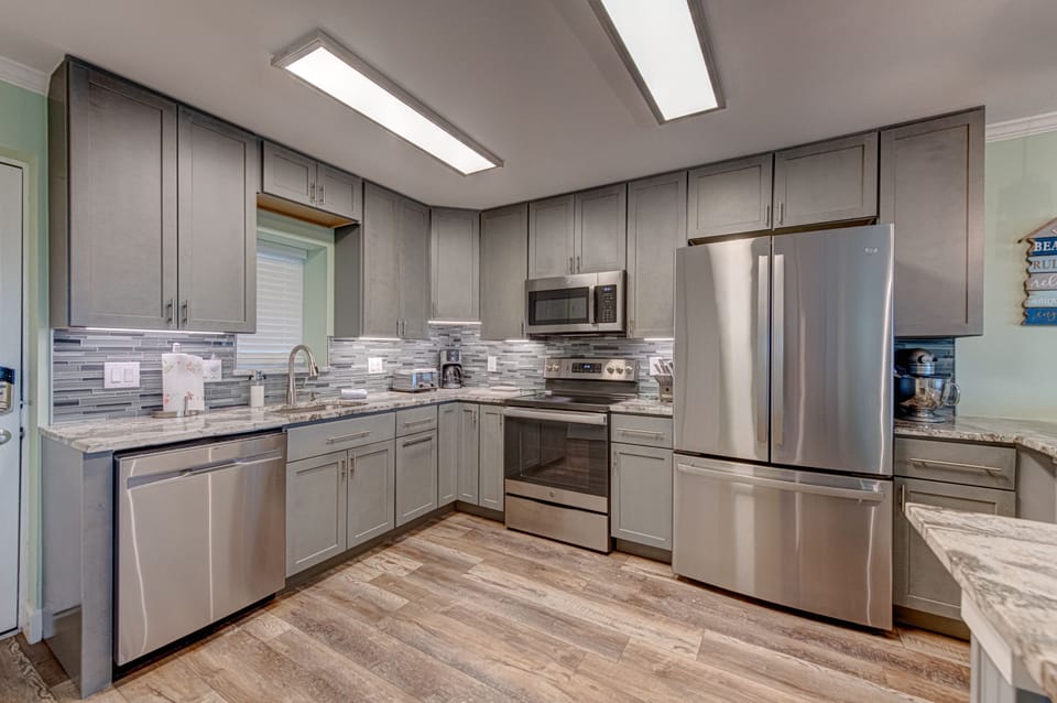 Your gourmet kitchen awaits with granite counters, stainless appliances, and skylights that bathe your culinary adventures in natural light.