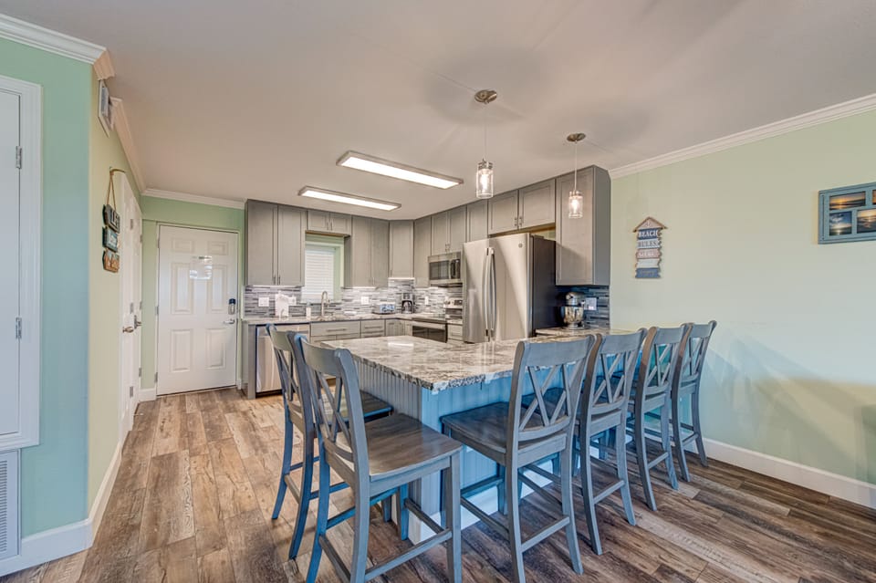 Your fully equipped kitchen features granite counters, stainless appliances, and breakfast bar seating for eight—perfect for cooking and gathering together.