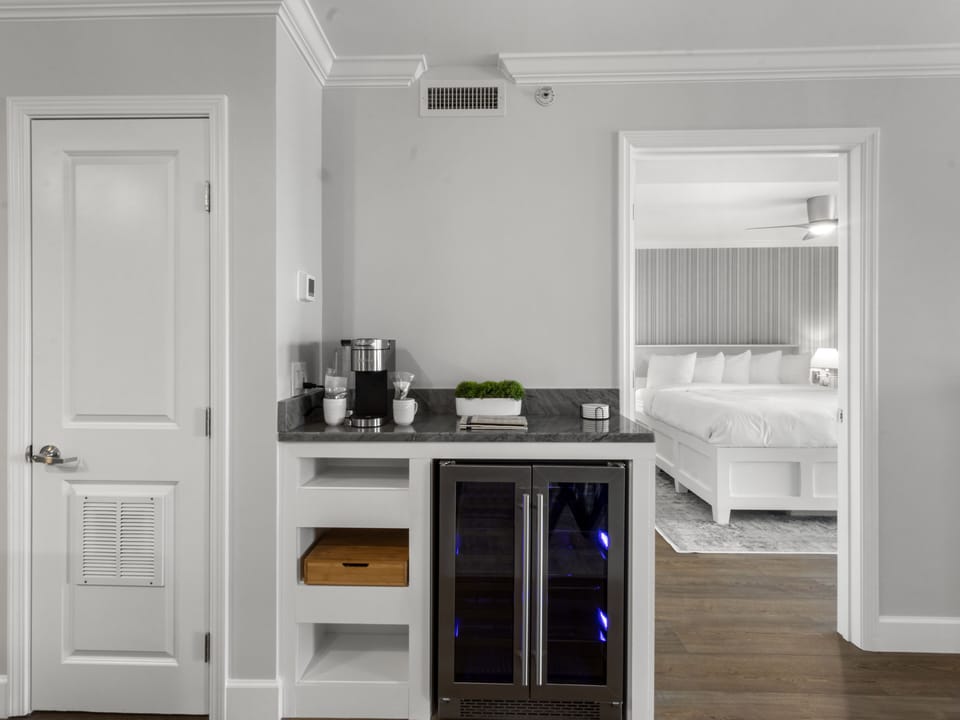 Your stylish kitchenette offers everything you need - coffee maker, wine cooler, and storage - with your comfortable bedroom just steps away.