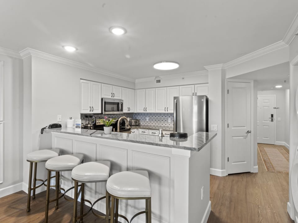 Your fully equipped kitchen features granite counters, stainless appliances, and a breakfast bar perfect for morning coffee or casual dining.