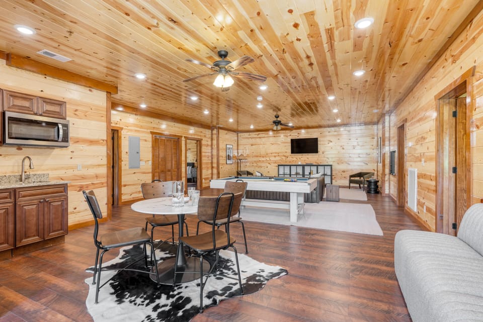 The downstairs level features another sitting area, pool table, card table, and small kitchenette.