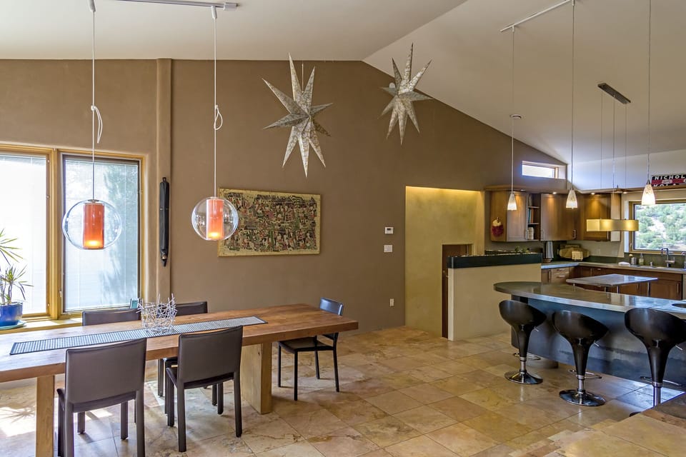 Open-plan living room, dining room, and kitchen, with doorway to private master.