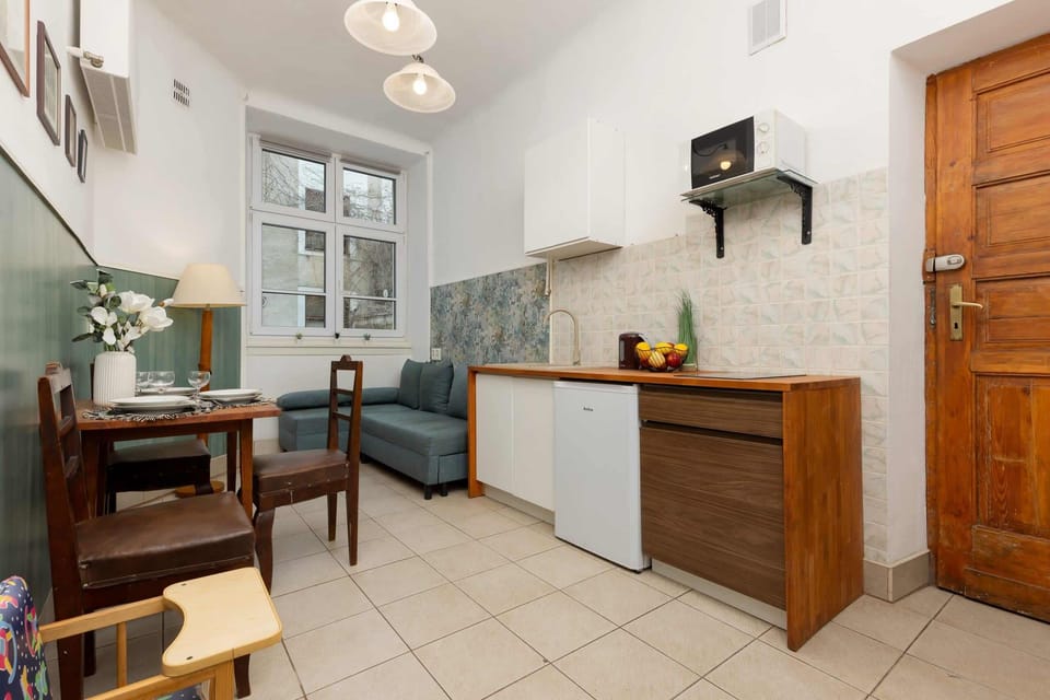 A stylish kitchen with a small dining area and modern design. The space is both functional and inviting.