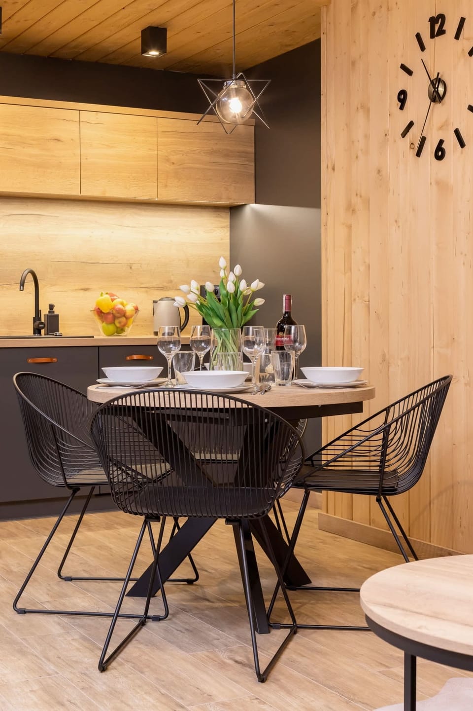 An intimate dining setup with a table for four, wooden accents, and a well-lit ambiance.