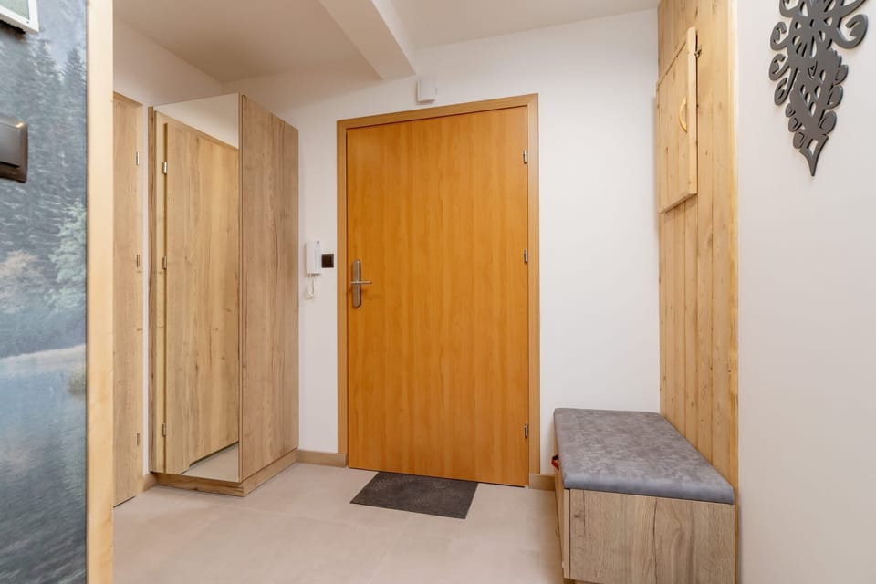 Bright and functional hallway with seating.