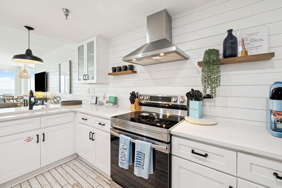 Cook your favorite meals in this bright, fully equipped kitchen with modern appliances and charming shiplap walls.