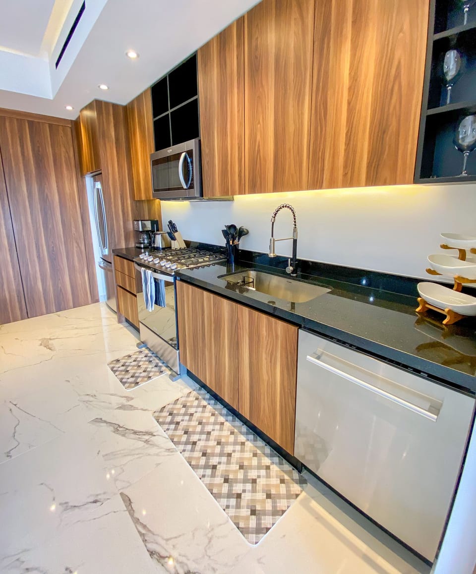 The kitchen is fully equipped with a full-size refrigerator, stove, oven and dishwasher