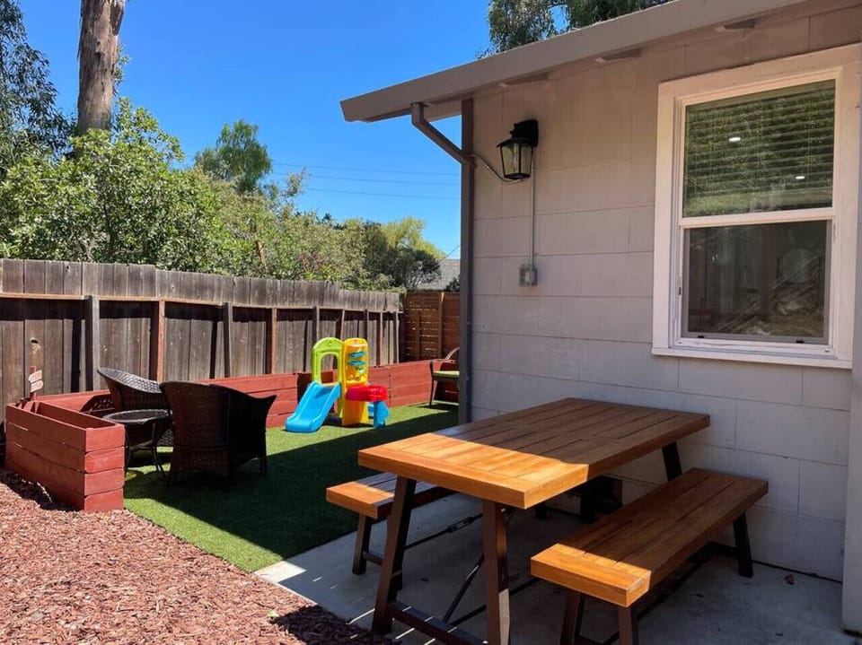Private backyard with picnic table and seating area.
