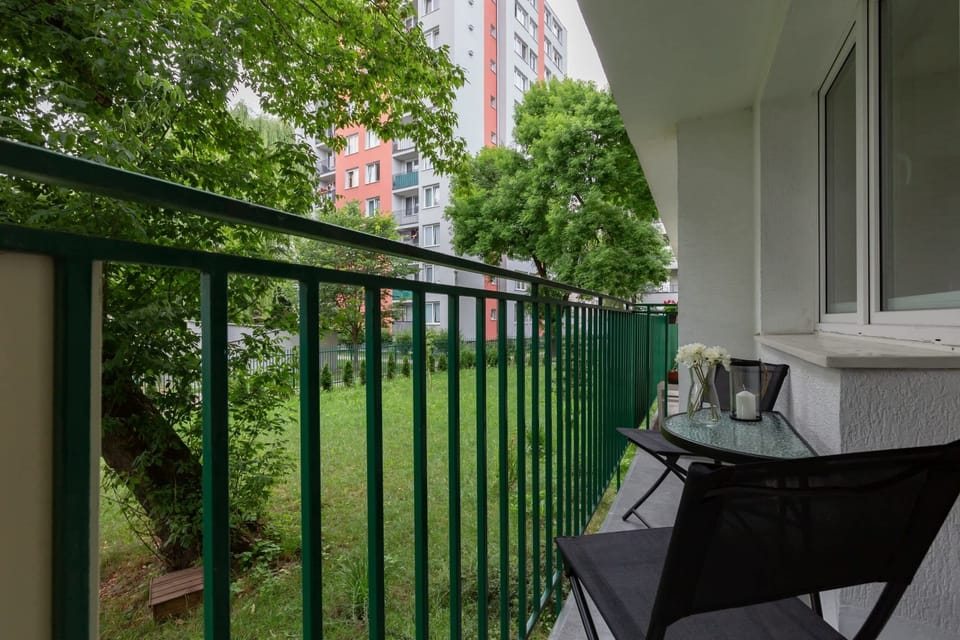 Furnished balcony with green surroundings. 