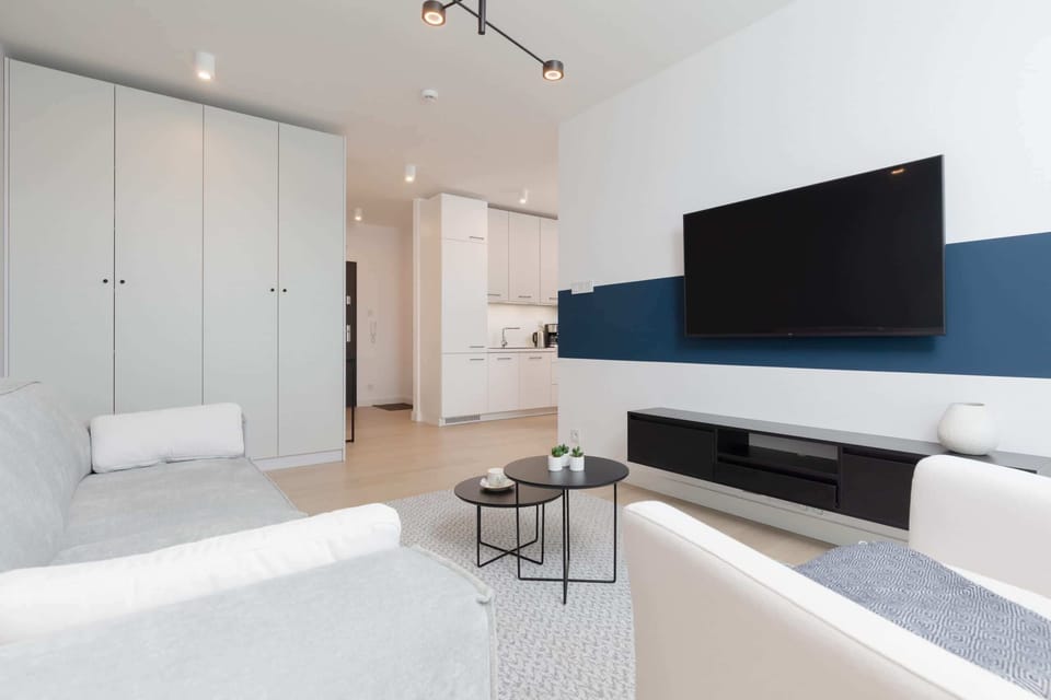 A spacious open-plan living area showing the connection between the living room and kitchen.