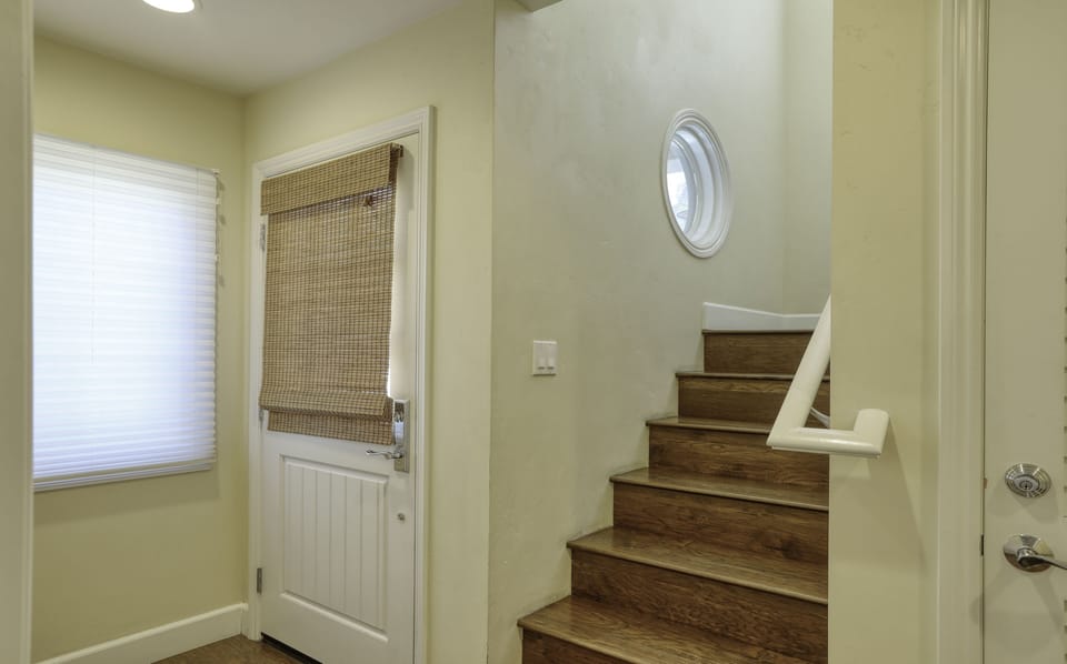 Entrance to the beach condo is thru the garage. At street level there is the first master bedroom. Up the flight of stairs to the main living, dining and second master bedroom.