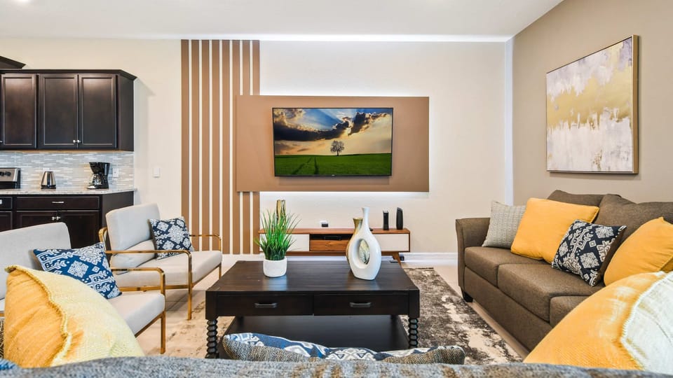 Stylish living area with warm accents, comfy seating, and modern design!