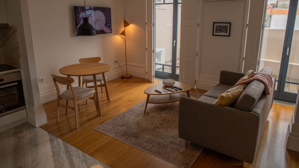 This lovely and ample living area is the perfect spot to rest after a long day visiting the city, with big windows that allow lots of natural to enter #bright #stunning #lovelystay #airbnbporto