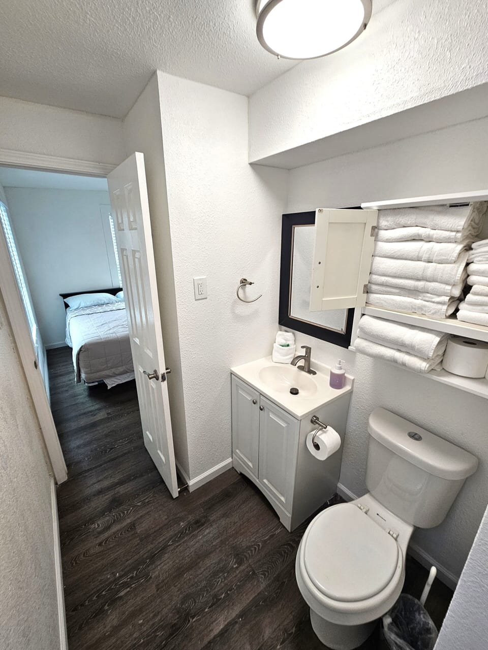 1st full bathroom (Main floor): shower, vanity, toilet, towel racks , towels.