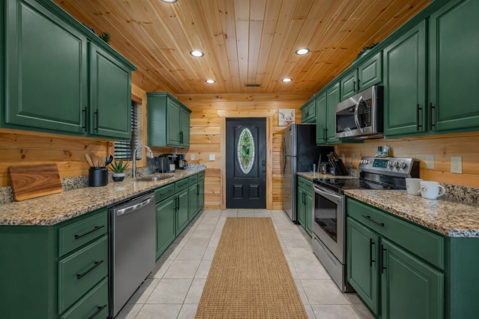 Rustic-chic galley kitchen with granite counters & stainless apps
