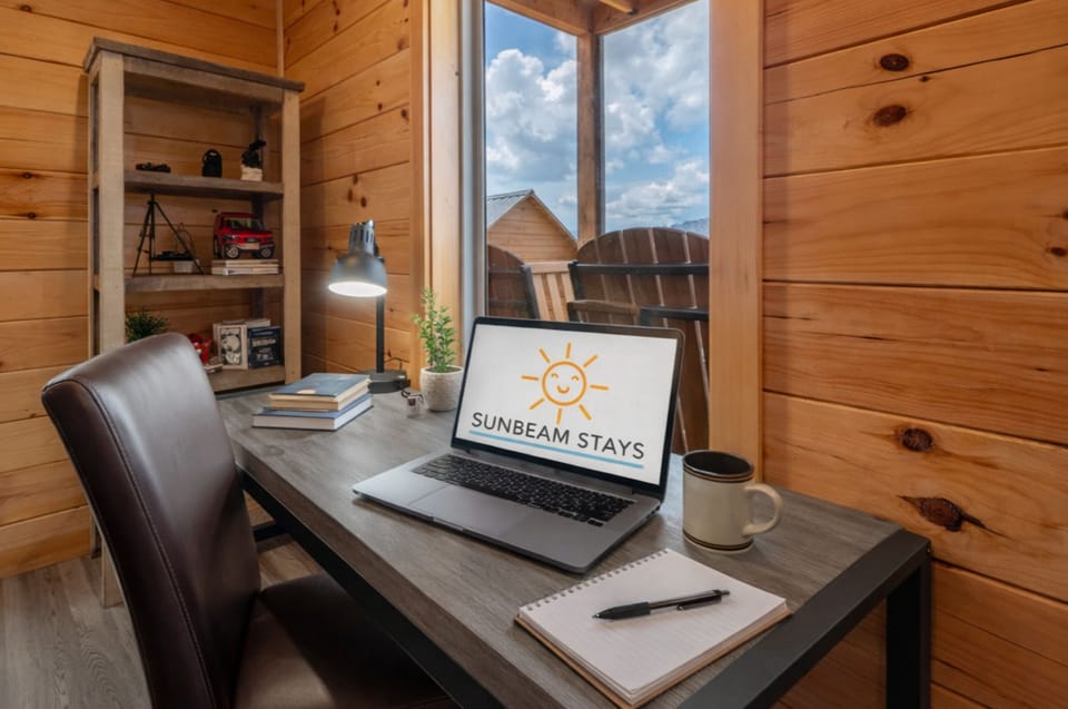 Cozy cabin workspace with natural light and scenic deck views