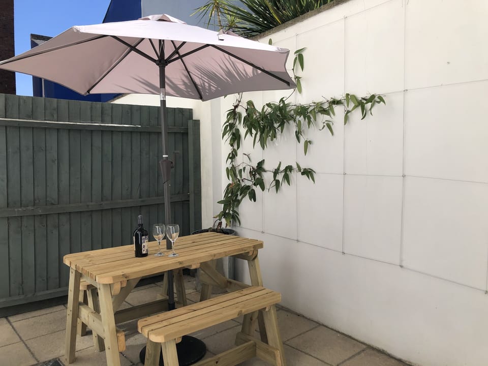 Relax in the sunny courtyard. Fragrant honeysuckle throughout the summer months