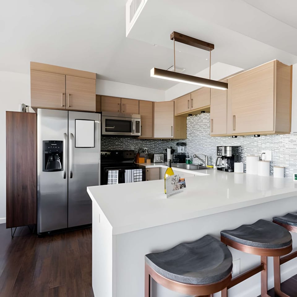 Complete kitchen view with a modern bar table, perfect for entertaining and meals