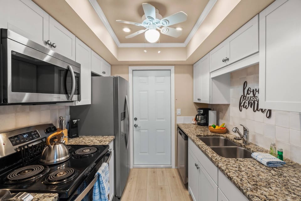 An updated kitchen stocked with cookware, making vacation dining a breeze.