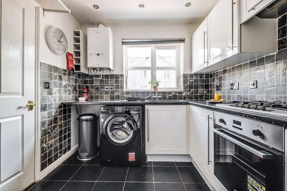Designed with convenience in mind, the kitchen is fully equipped and includes a washing machine—perfect for longer stays