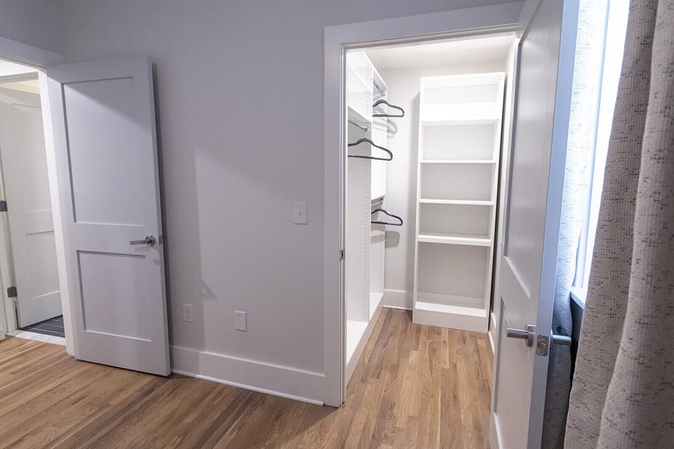 Bedroom showing the walk-in closet entrance and the bathroom entrance.