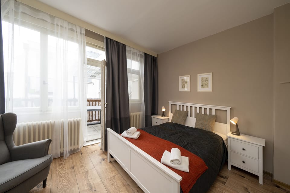 Bedroom 1 with balcony, double bed, wardrobe and work desk 