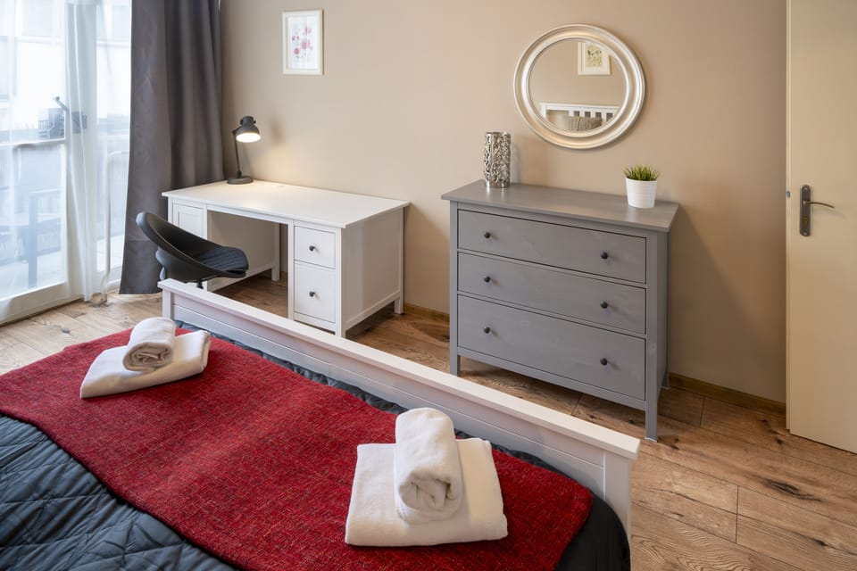 Bedroom 2 with balcony, double bed, wardrobe and work desk 