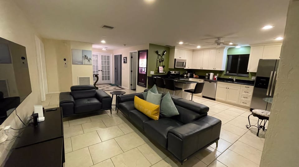 Living area onlooking kitchen and door to bedroom #3