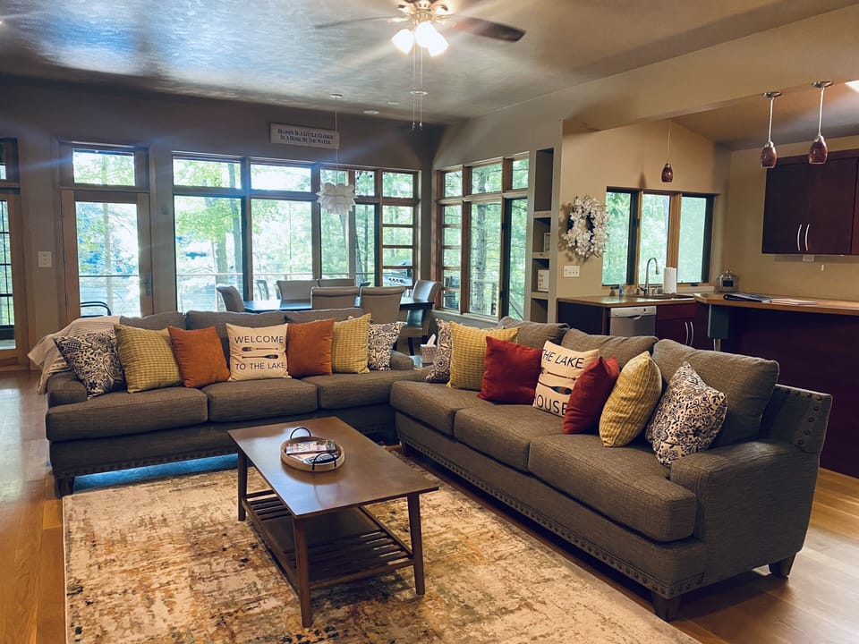 Living Room with two full size sofas, Smart TV. Open concept to kitchen/dining.
