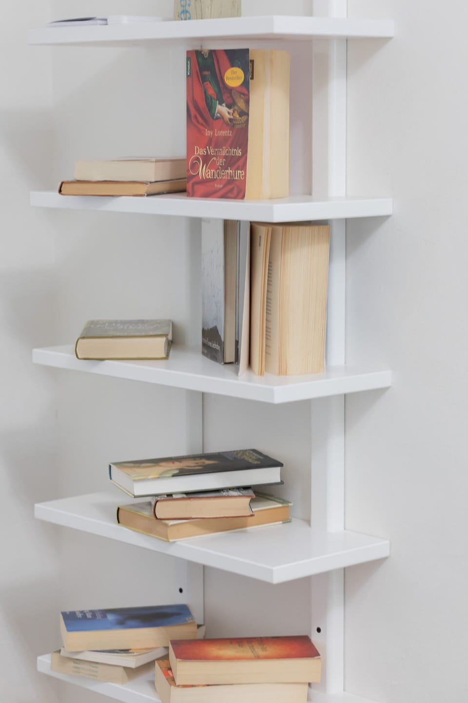 A close-up of the bookshelf with books and decorative items, adding a cozy touch.
