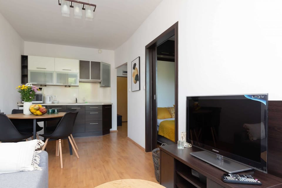 A second view of the kitchen area, highlighting the dining table and bright interiors.
