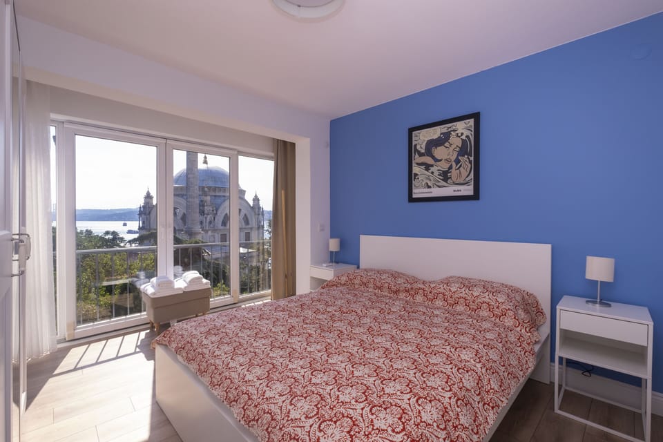 Blue bedroom — French doors onto the mosque and the water