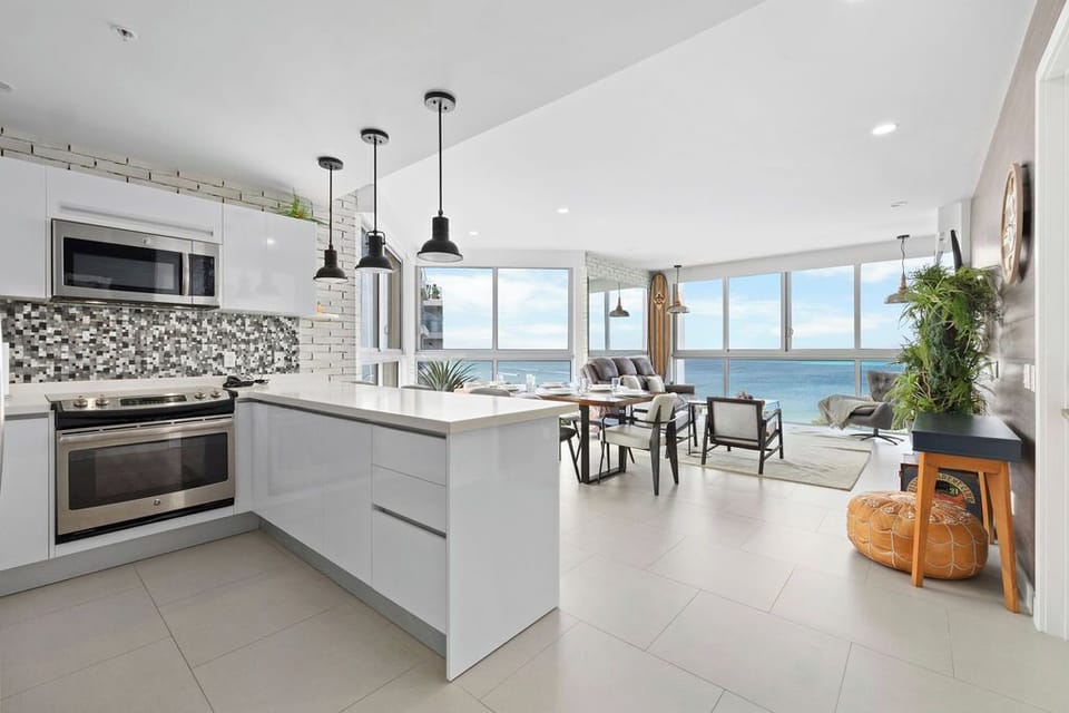 Your open-plan kitchen and living area flow effortlessly into stunning ocean vistas. Modern finishes, sleek countertops, and abundant natural light create a bright, welcoming space where you'll love cooking and relaxing.