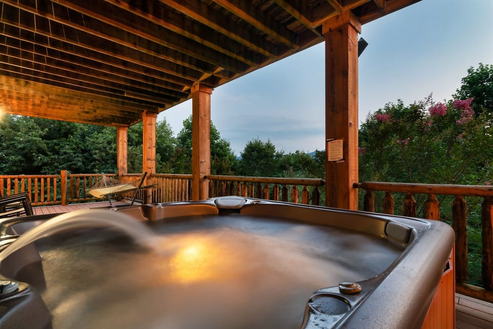 Outdoor Retreat: Indulge in the hot tub with panoramic views of the Smoky Mountains at sunset!