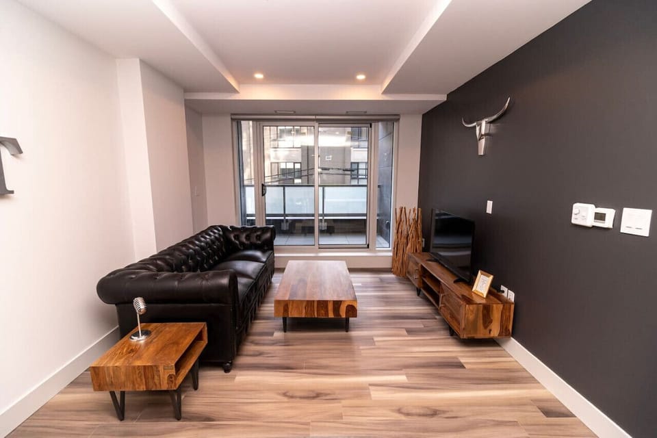 Unwind in the stylish living room with expansive skyline views. Settle into the cozy seating and enjoy your favorite shows on the Smart TV.