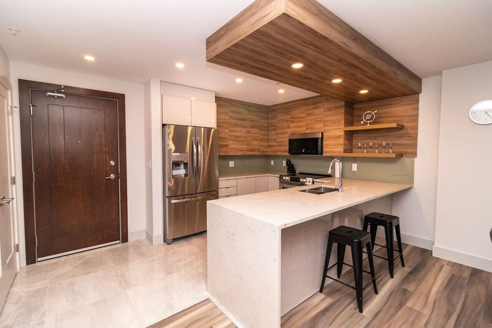 Prepare meals with ease in the modern, fully-equipped kitchen, complete with top-tier appliances and sleek finishes.